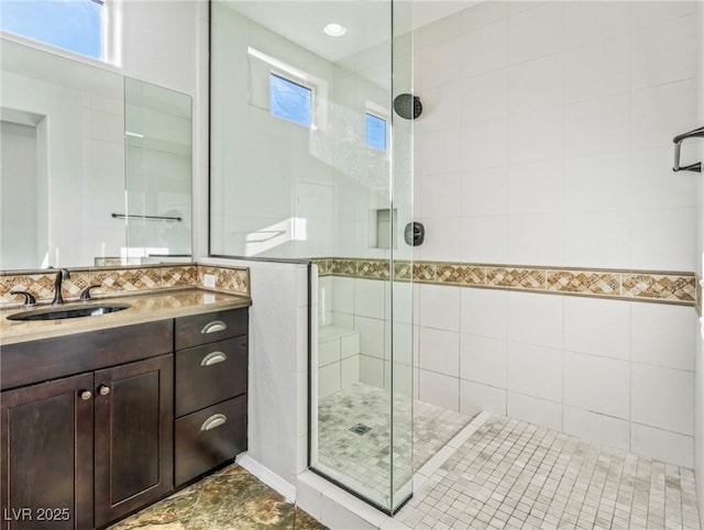 bathroom with vanity and a shower with shower door