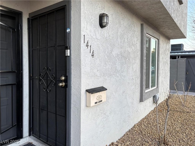 entrance to property featuring cooling unit