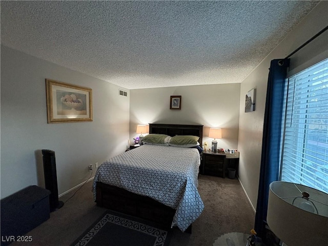 bedroom with carpet and a textured ceiling