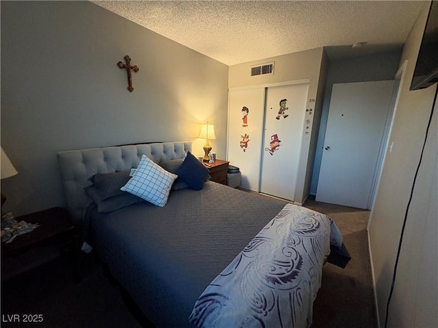 bedroom with carpet floors, a textured ceiling, and a closet