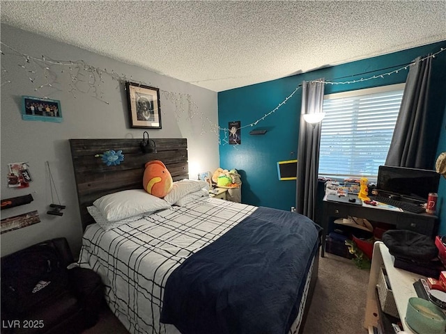 bedroom with a textured ceiling and carpet flooring