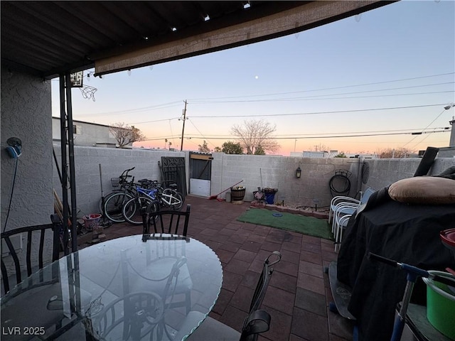 patio terrace at dusk with a grill