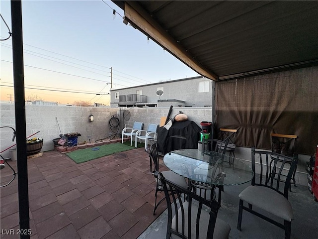 view of patio terrace at dusk