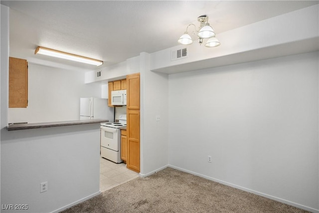 kitchen featuring visible vents, white appliances, baseboards, light colored carpet, and a notable chandelier