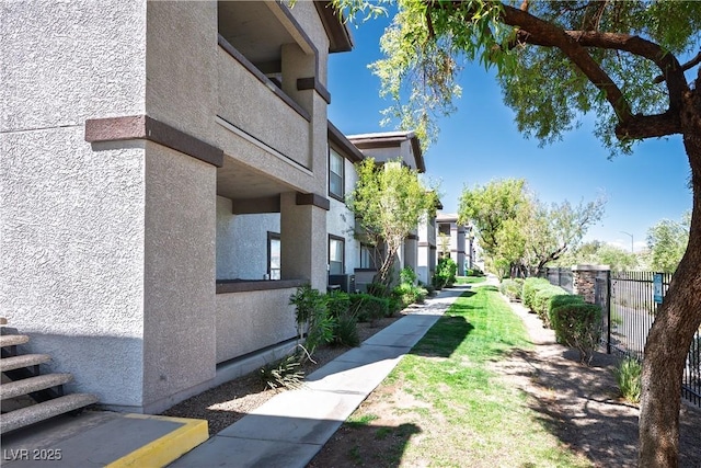 view of community featuring fence and a residential view