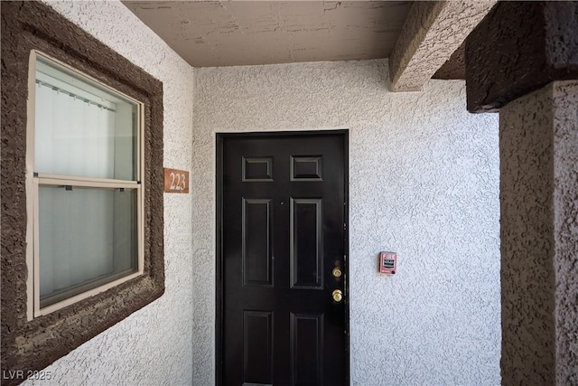 property entrance featuring stucco siding
