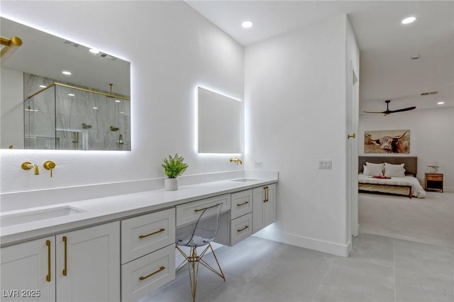 bathroom with ceiling fan, vanity, and a shower with shower door