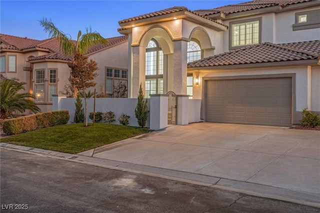 mediterranean / spanish house featuring a lawn and a garage