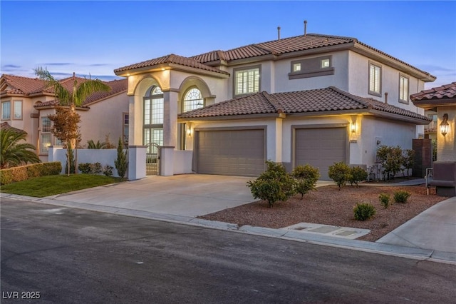 mediterranean / spanish home featuring a garage