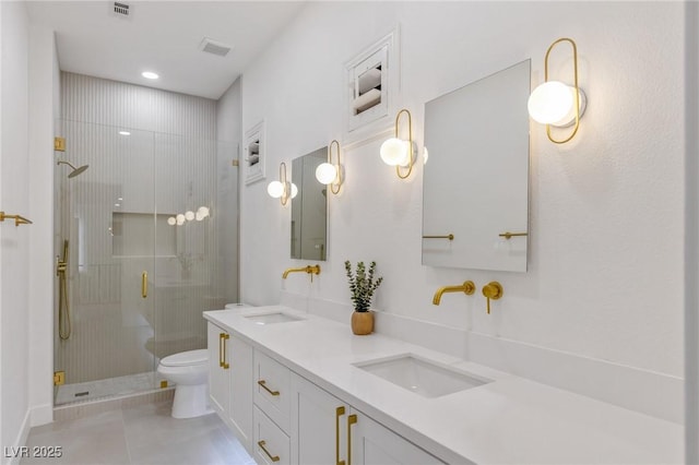 bathroom with tile patterned flooring, vanity, toilet, and a shower with door