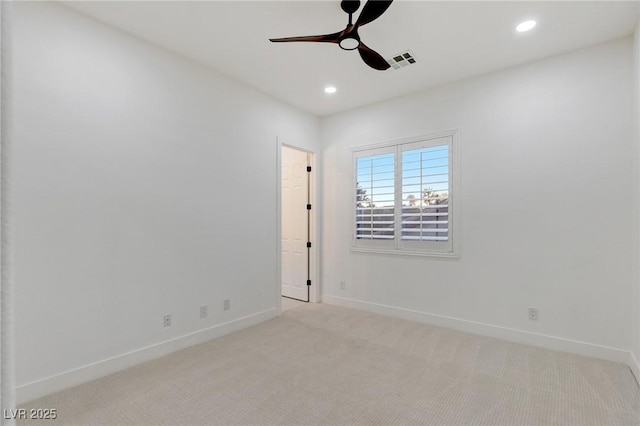 carpeted spare room with ceiling fan