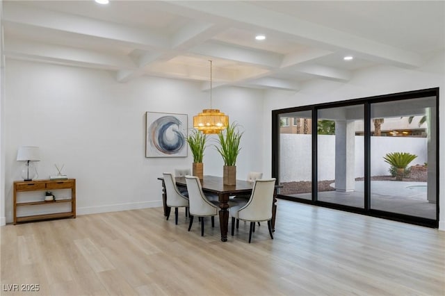 dining space with beamed ceiling, a notable chandelier, and light hardwood / wood-style floors