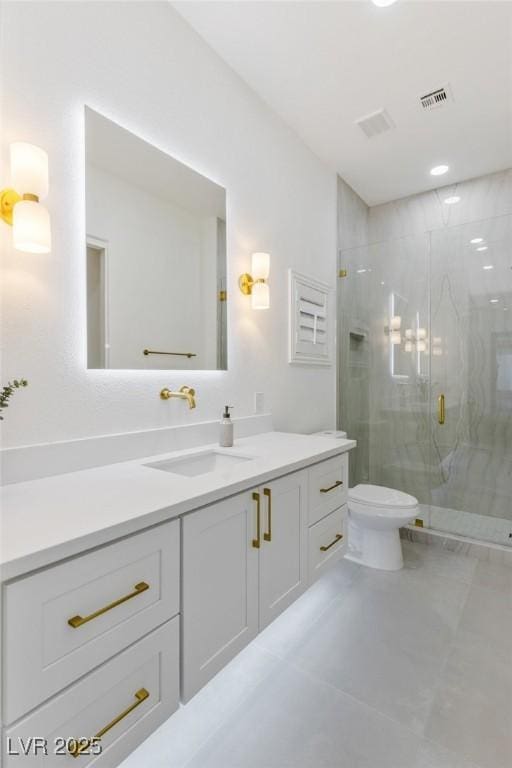 bathroom with tile patterned floors, vanity, toilet, and a shower with door