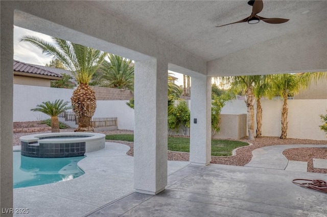 view of patio featuring an in ground hot tub and ceiling fan