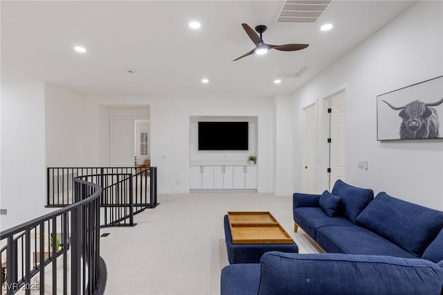 living room featuring light carpet and ceiling fan