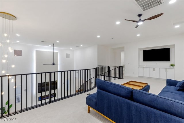 living room featuring ceiling fan and light carpet