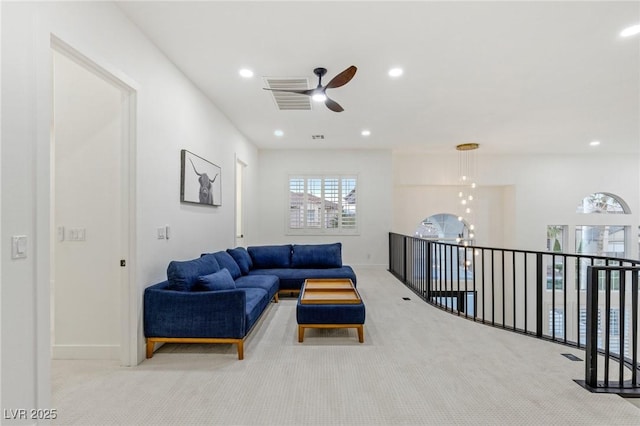 living room with ceiling fan and light carpet