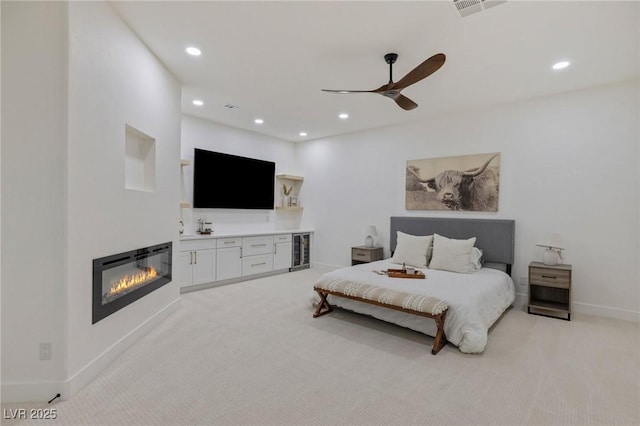 carpeted bedroom featuring ceiling fan and beverage cooler