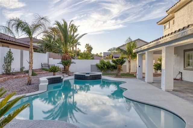 view of swimming pool with a patio area and an in ground hot tub