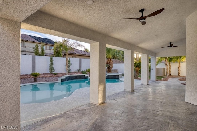 view of swimming pool featuring ceiling fan and a patio area