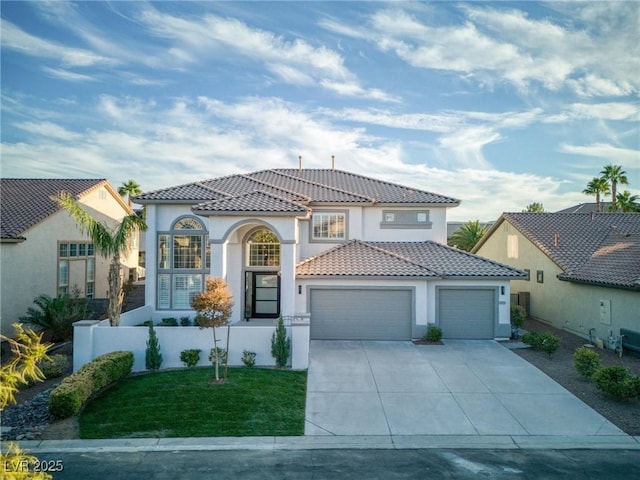 mediterranean / spanish home featuring a garage and a front lawn