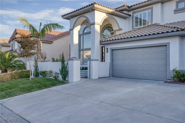 mediterranean / spanish-style home with a front yard and a garage