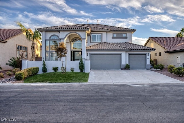 mediterranean / spanish-style house featuring a front yard and a garage