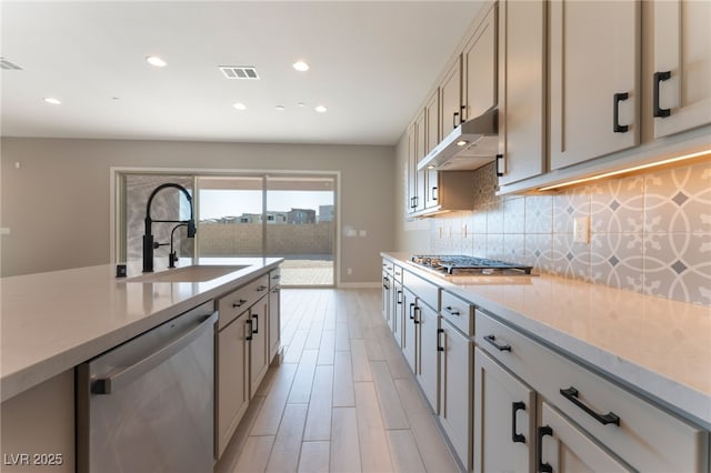 kitchen featuring light wood-type flooring, sink, and appliances with stainless steel finishes