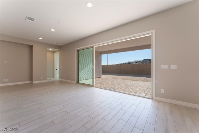 spare room featuring light hardwood / wood-style floors