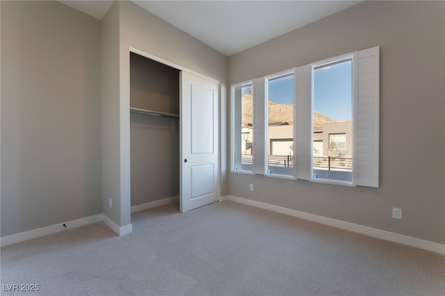 unfurnished bedroom featuring carpet and a closet