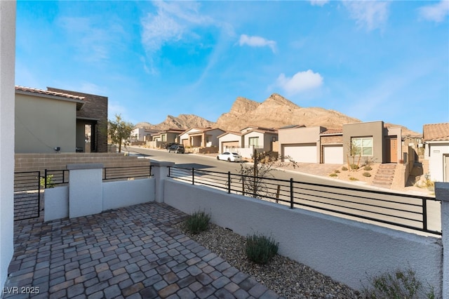 view of patio with a mountain view and a garage