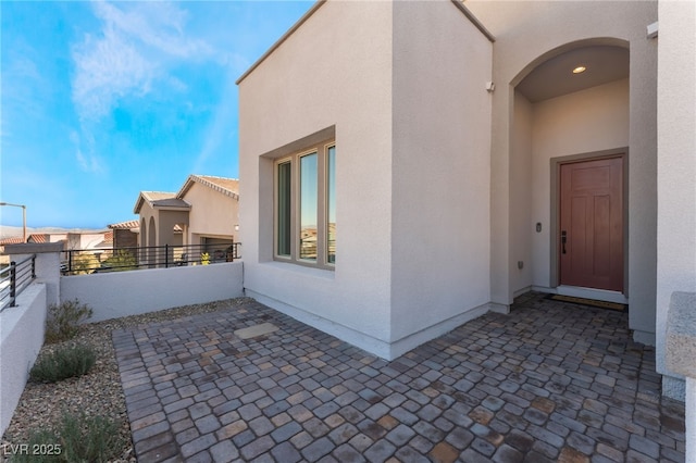 view of exterior entry with a patio