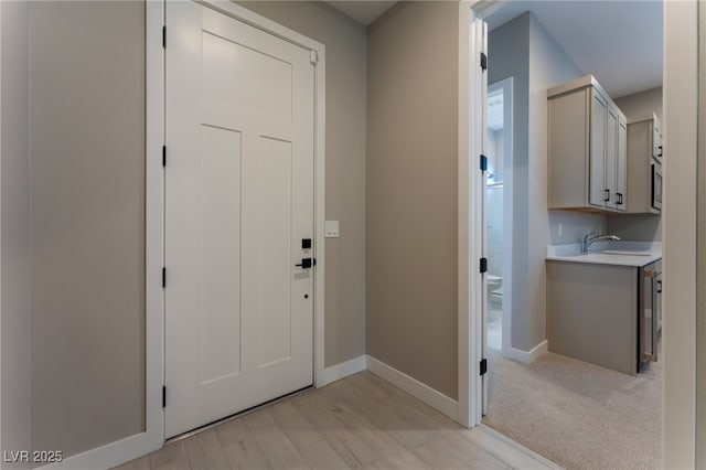 entryway featuring light hardwood / wood-style flooring and sink