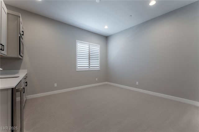 interior space featuring light carpet and sink