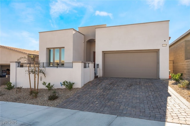 pueblo-style home featuring a garage