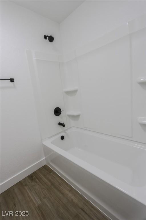 bathroom with shower / bathing tub combination and wood-type flooring