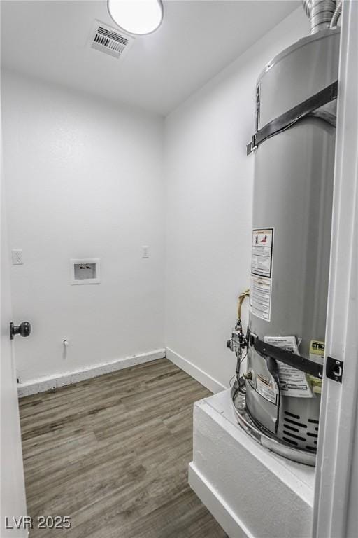 utility room featuring secured water heater