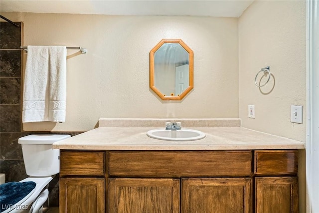 bathroom featuring toilet and vanity