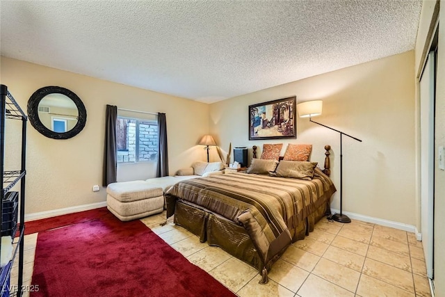 bedroom with a textured ceiling and light tile patterned floors