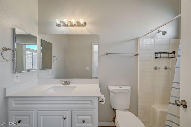 bathroom with curtained shower, vanity, and toilet