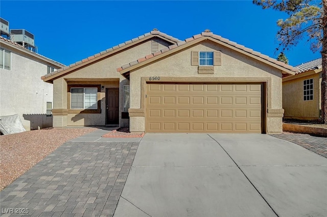 ranch-style house with central AC unit and a garage