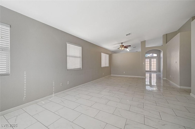 empty room featuring french doors and ceiling fan