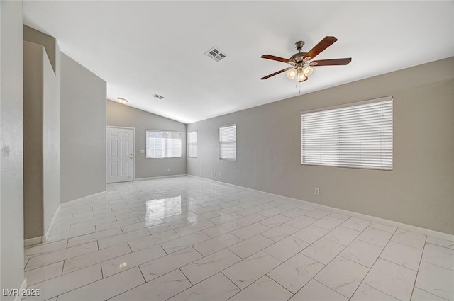 empty room with ceiling fan and vaulted ceiling