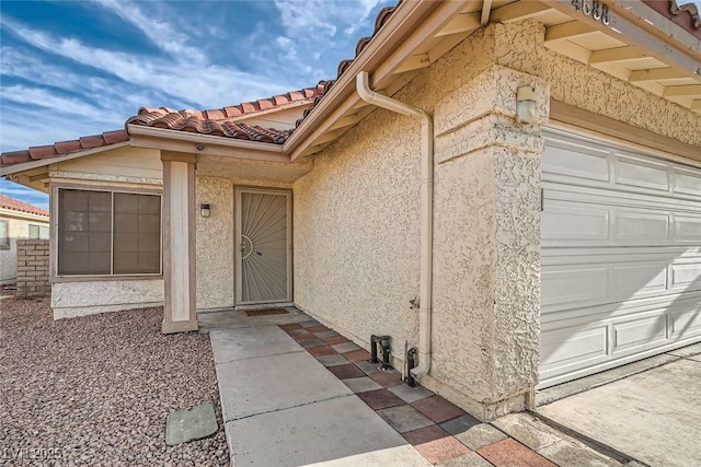 view of exterior entry featuring a garage