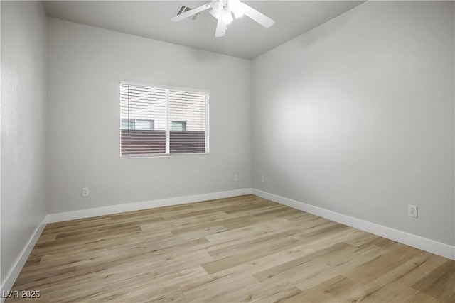 empty room featuring visible vents, baseboards, a ceiling fan, and light wood finished floors