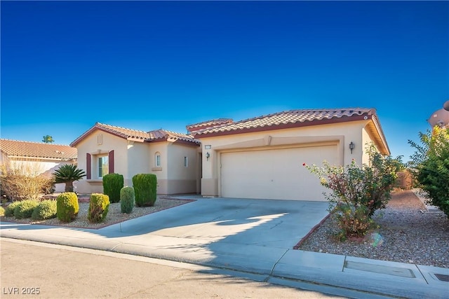 mediterranean / spanish house featuring stucco siding, a garage, driveway, and a tile roof