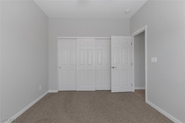 unfurnished bedroom featuring carpet flooring and a closet