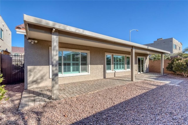 back of property with a patio