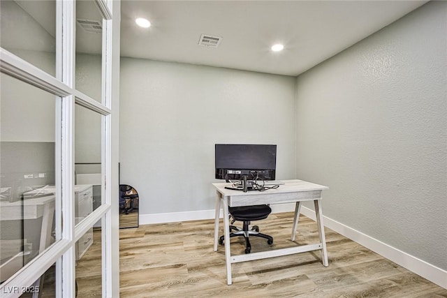 office space with hardwood / wood-style flooring