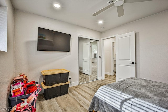 bedroom featuring hardwood / wood-style floors, ceiling fan, and a closet